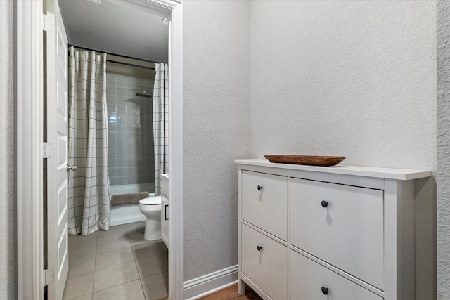 bathroom with toilet, tile patterned flooring, and a shower with shower curtain