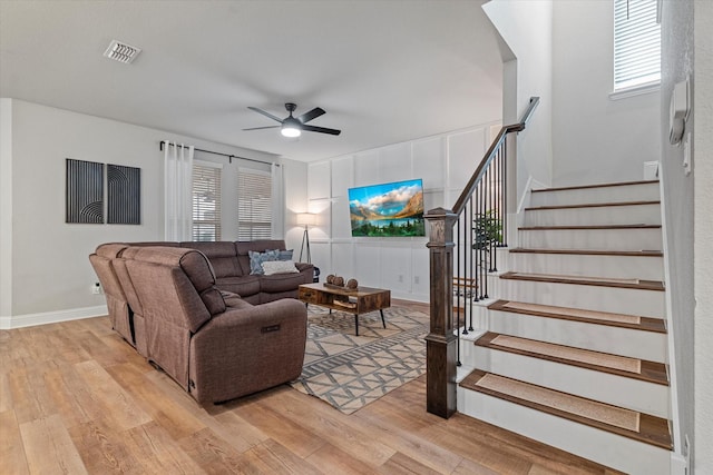 living room with ceiling fan and light wood-type flooring