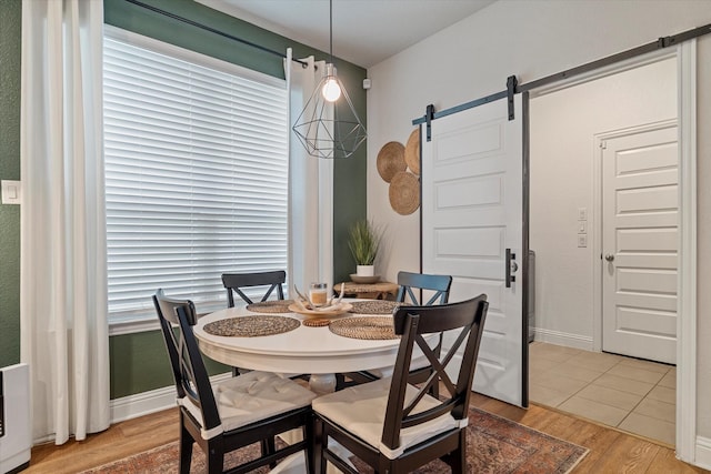 10012 Travis Dr, Providence Village, TX 76227 - dining room featuring a barn door and light wood finished floors