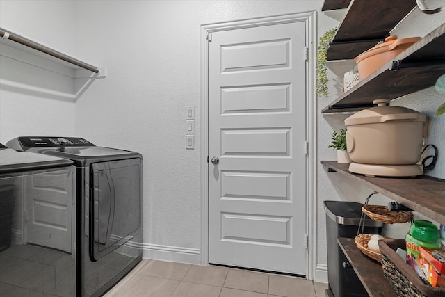 10012 Travis Dr, Providence Village, TX 76227 - washroom with washing machine and clothes dryer, light tile patterned floors, and baseboards