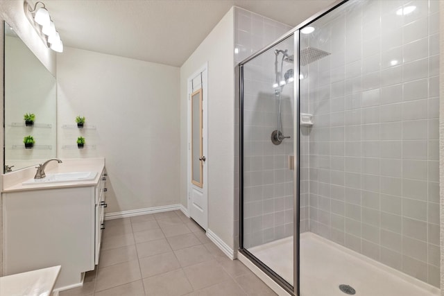 bathroom with tile patterned floors, vanity, and a shower with shower door