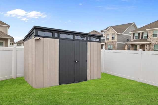 view of outbuilding featuring a yard