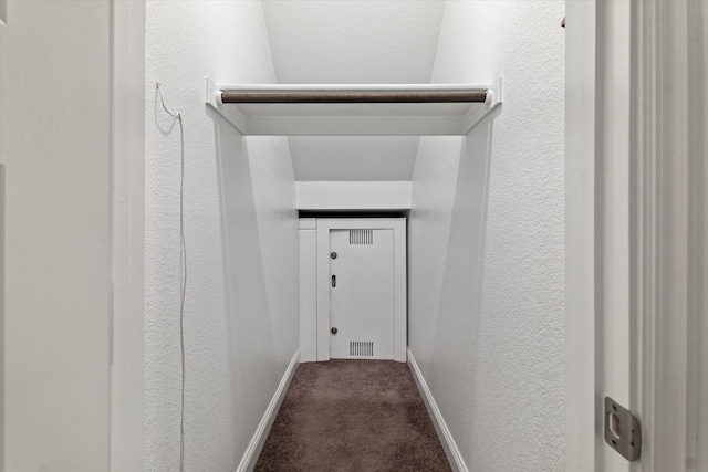 interior space featuring dark colored carpet