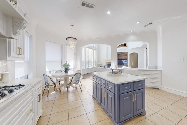 788 Windsong Ln, Rockwall, TX 75032 - kitchen featuring white cabinets, blue cabinets, light countertops, crown molding, and recessed lighting