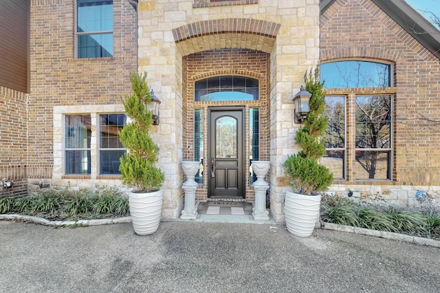 788 Windsong Ln, Rockwall, TX 75032 - view of exterior entry featuring stone siding and brick siding