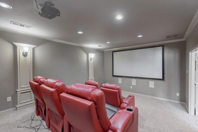 carpeted home theater featuring ornate columns and ornamental molding