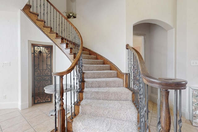 788 Windsong Ln, Rockwall, TX 75032 - stairway featuring arched walkways, tile patterned flooring, and baseboards