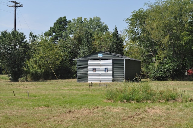 view of outbuilding featuring a lawn