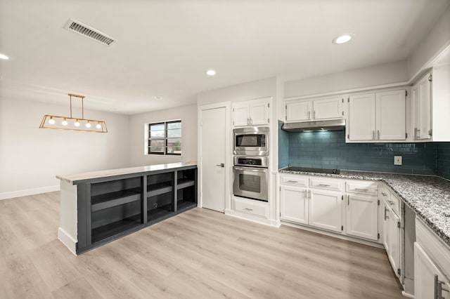 kitchen featuring white cabinets, appliances with stainless steel finishes, backsplash, and decorative light fixtures