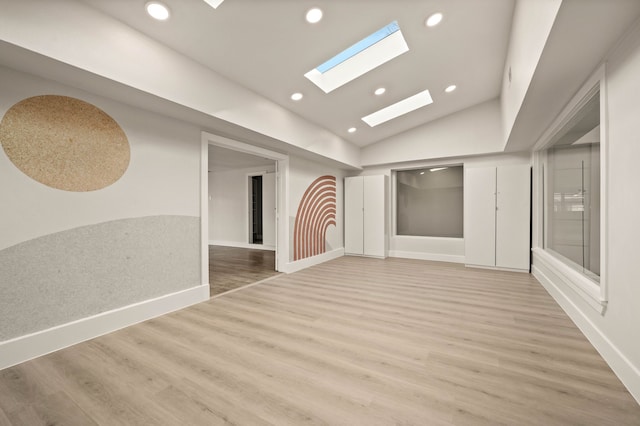 spare room featuring hardwood / wood-style floors and lofted ceiling