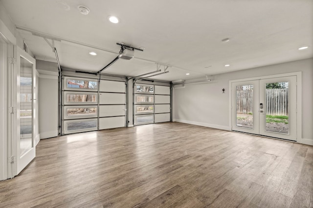 garage with french doors and a garage door opener