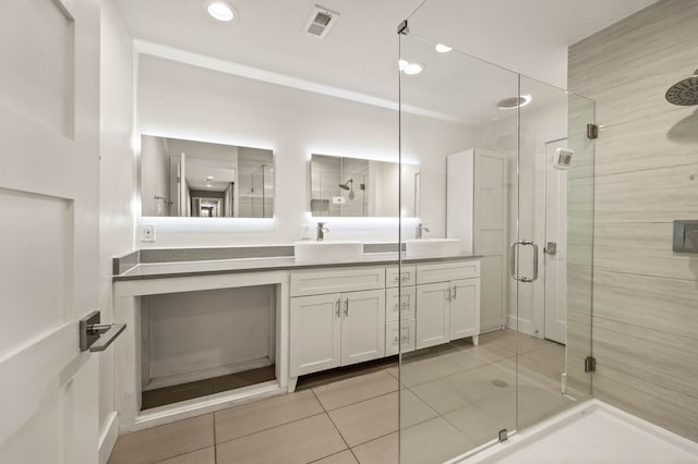 bathroom with vanity, tile patterned flooring, and walk in shower