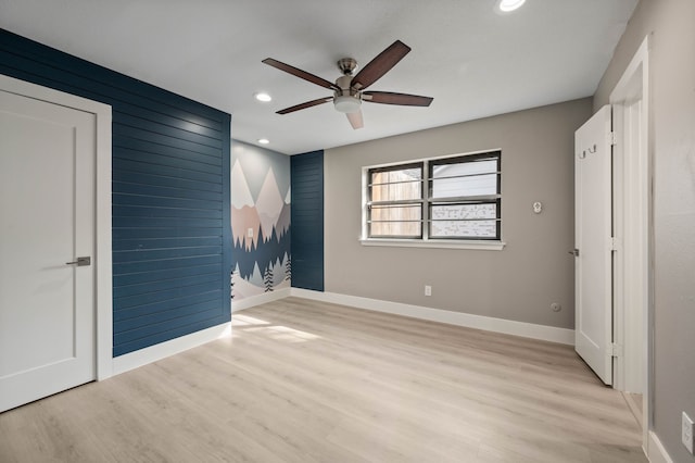 unfurnished bedroom with ceiling fan and light hardwood / wood-style flooring