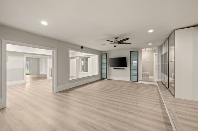 unfurnished living room featuring light hardwood / wood-style floors and ceiling fan