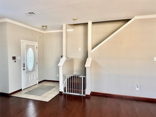 entryway featuring hardwood / wood-style floors and crown molding