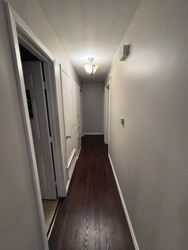 2732 Foxcroft Cir, Denton, TX 76209 - hallway with dark wood-style flooring, baseboards, and a textured ceiling