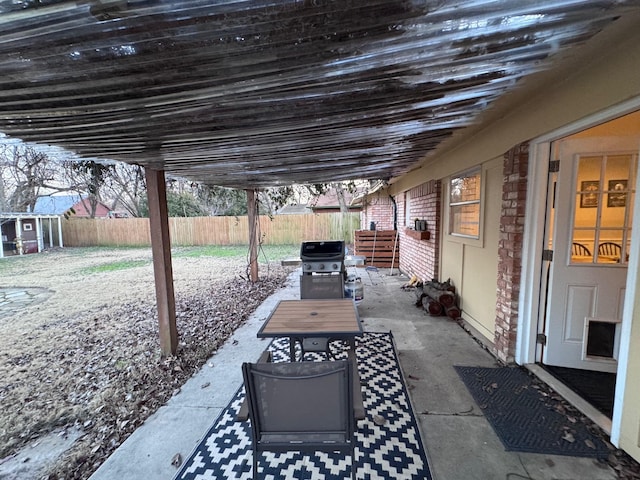 2732 Foxcroft Cir, Denton, TX 76209 - view of patio featuring a grill, a fenced backyard, an outdoor structure, and a storage shed