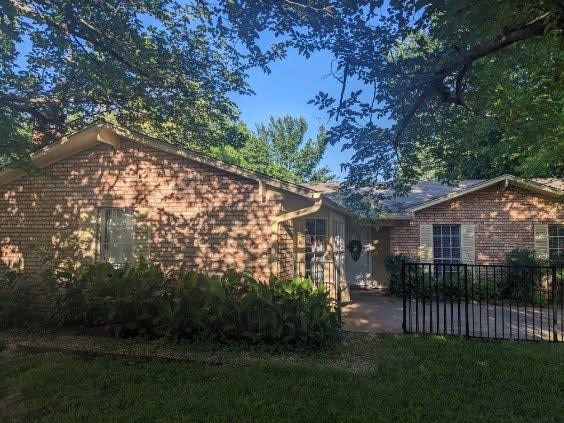 2732 Foxcroft Cir, Denton, TX 76209 - view of property exterior featuring brick siding and a patio