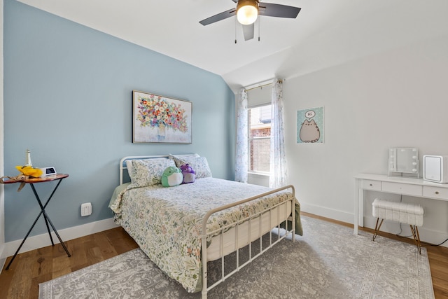 bedroom featuring ceiling fan, vaulted ceiling, and wood-type flooring