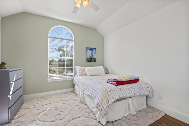 bedroom featuring lofted ceiling, ceiling fan, and light hardwood / wood-style flooring