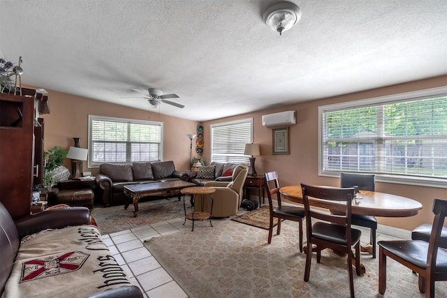 417 Athenia Dr, Fort Worth, TX 76114 - living room with a textured ceiling, a wall mounted air conditioner, ceiling fan, and light tile patterned floors