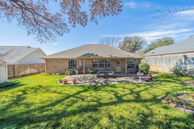 rear view of house featuring a yard and a patio area