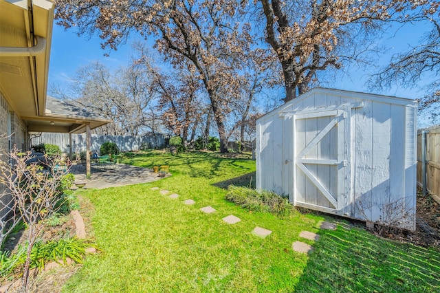 view of yard featuring a patio and a storage shed