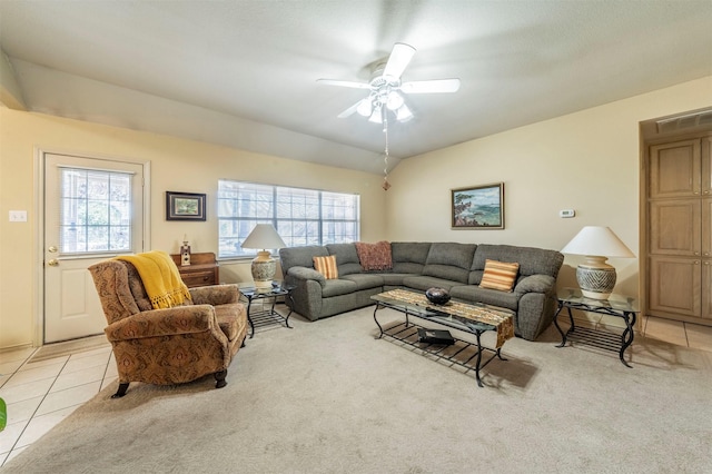 tiled living room with ceiling fan, vaulted ceiling, and a wealth of natural light