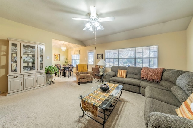 carpeted living room with lofted ceiling and ceiling fan