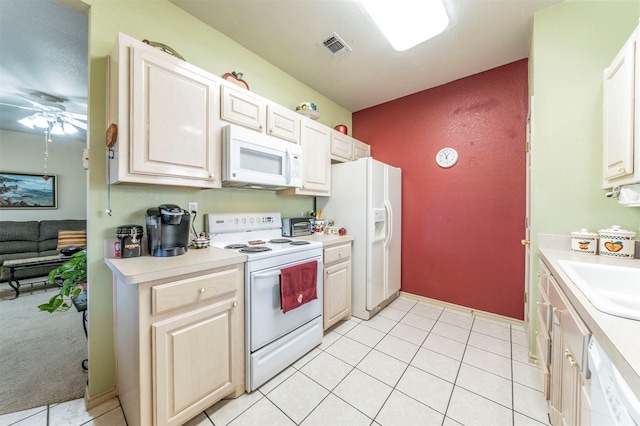 kitchen with white appliances, ceiling fan, light tile patterned floors, and sink