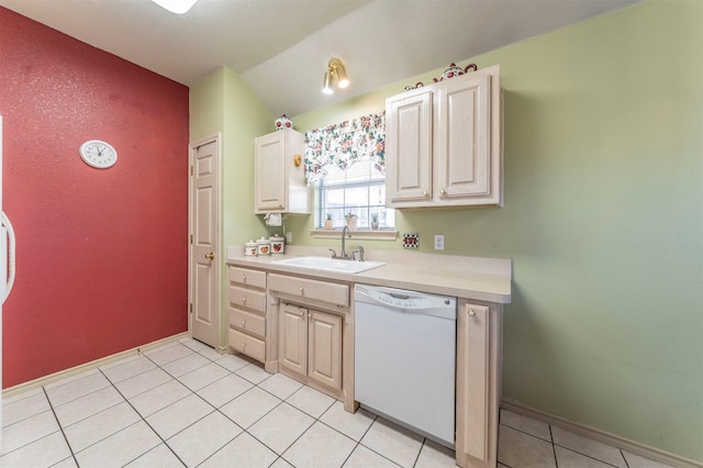 kitchen with light tile patterned floors, white dishwasher, and sink