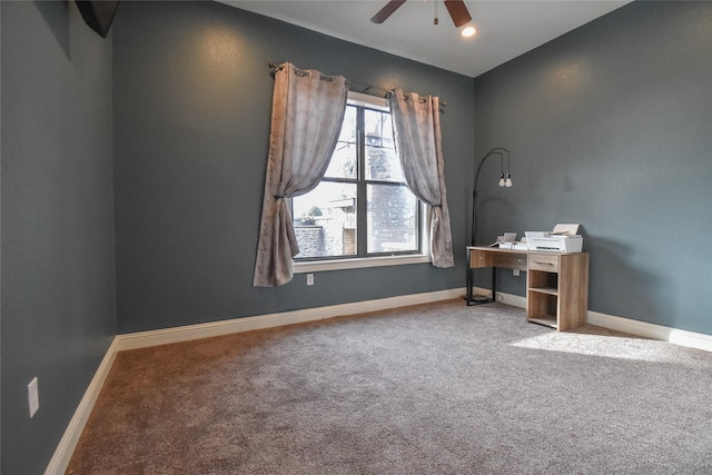 unfurnished office featuring carpet flooring and ceiling fan