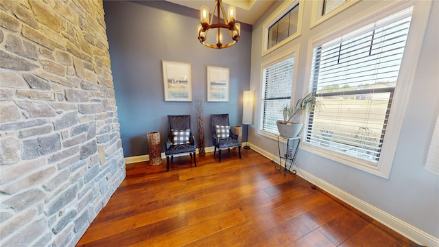 sitting room featuring an inviting chandelier and dark hardwood / wood-style flooring