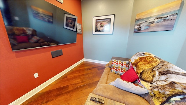 sitting room with wood-type flooring