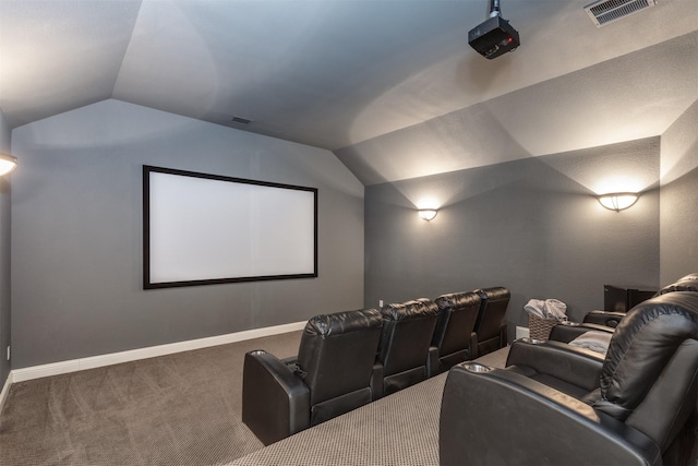 carpeted cinema room with vaulted ceiling, visible vents, and baseboards