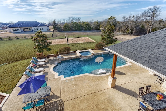 view of swimming pool with a pool with connected hot tub, a fenced backyard, a lawn, and a patio