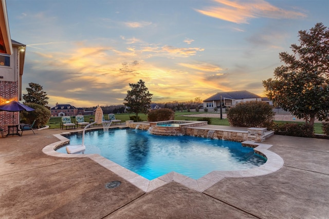 pool at dusk with a pool with connected hot tub and a patio