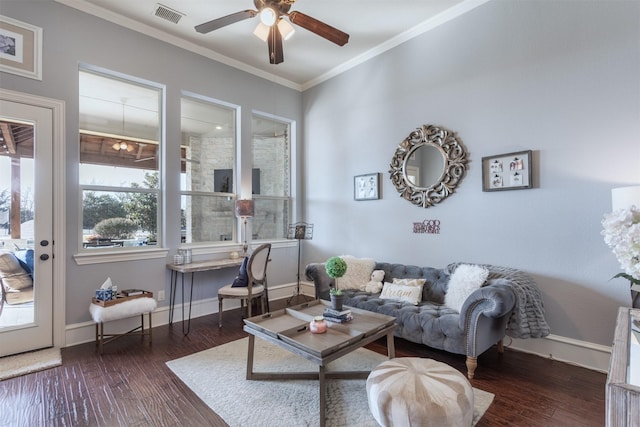 living area featuring visible vents, baseboards, dark wood-type flooring, and crown molding