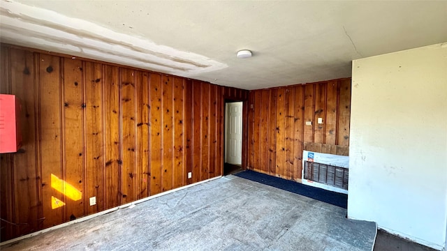 empty room featuring wood walls