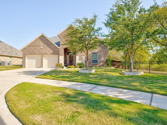 view of front facade with brick siding, concrete driveway, an attached garage, fence, and a front yard