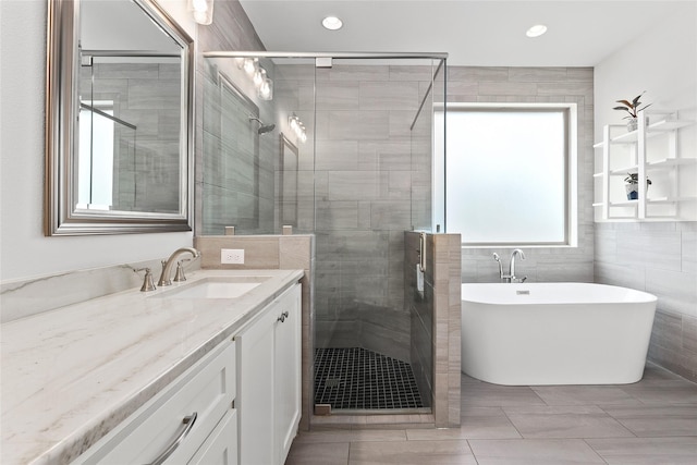 full bathroom with recessed lighting, a soaking tub, a shower stall, and vanity