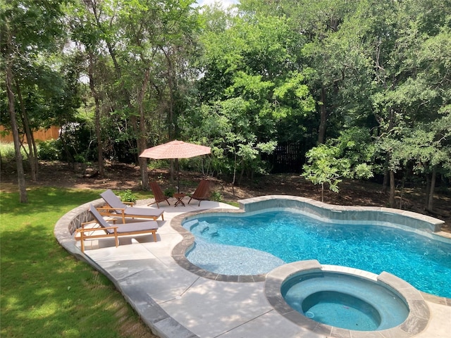 view of pool featuring a pool with connected hot tub and fence