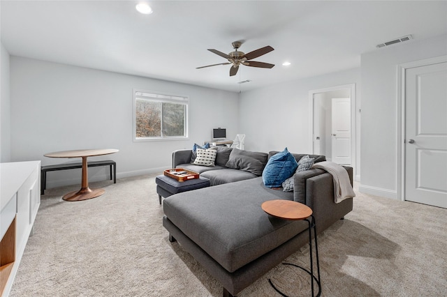 living room with recessed lighting, visible vents, baseboards, and light colored carpet