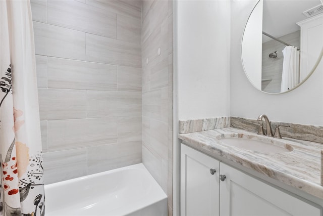 full bath with visible vents, vanity, and shower / bath combo with shower curtain