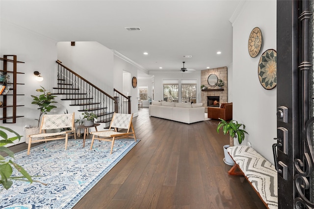 entryway featuring stairs, dark wood-type flooring, visible vents, and crown molding