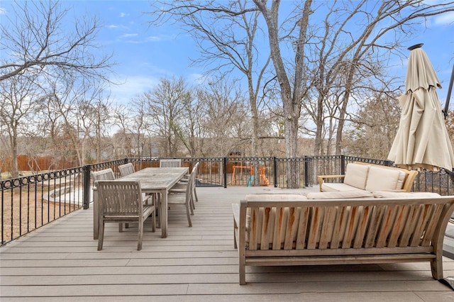 wooden terrace featuring outdoor dining area and an outdoor hangout area