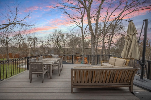 deck at dusk featuring outdoor dining space and outdoor lounge area