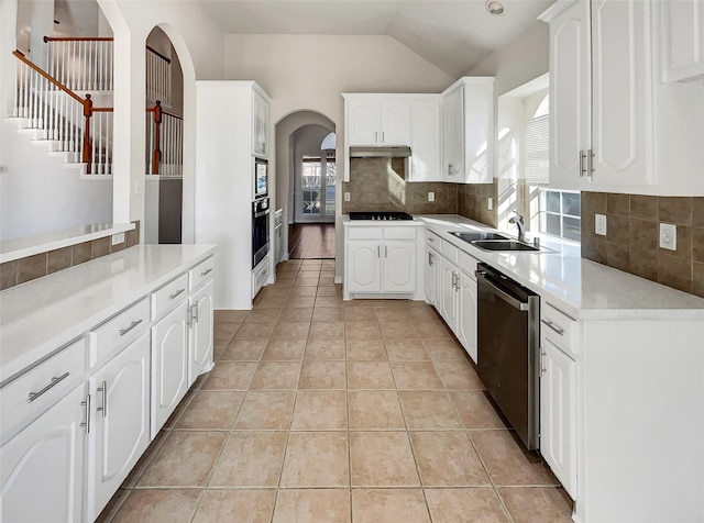 kitchen featuring sink, white cabinets, stainless steel appliances, and light tile patterned floors