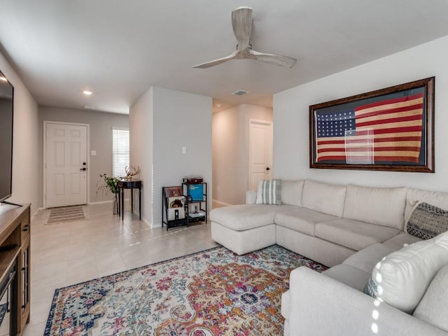 tiled living room featuring ceiling fan