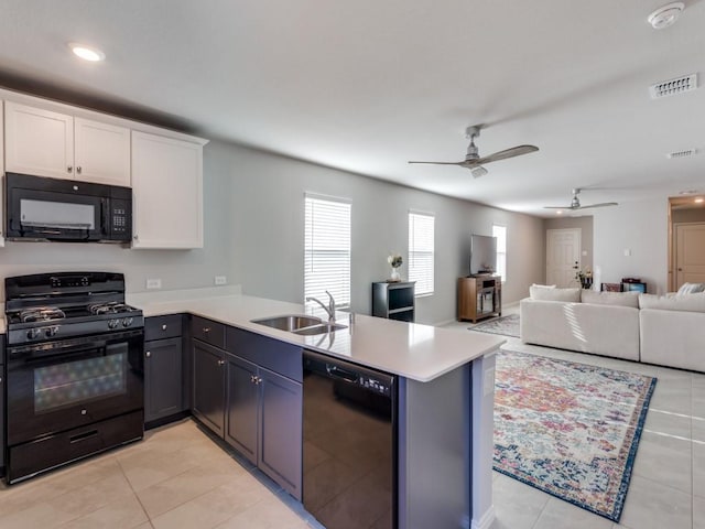 kitchen featuring black appliances, light tile patterned floors, sink, white cabinetry, and kitchen peninsula